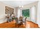 Bright dining area features wood floors, table with seating for four, and a view of the green yard at 21705 67Th E Ave, Bradenton, FL 34211