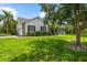 Charming single-story home with lush green lawn, mature trees, and lovely landscaping at 21705 67Th E Ave, Bradenton, FL 34211