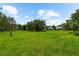 Expansive green lawn with mature trees, providing a peaceful and picturesque setting at 21705 67Th E Ave, Bradenton, FL 34211