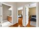 Hallway featuring three doorways that lead to bedrooms and a bathroom with hardwood flooring at 21705 67Th E Ave, Bradenton, FL 34211