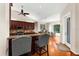 Open-concept kitchen and breakfast nook with cherry cabinets, granite countertops, and hardwood flooring at 21705 67Th E Ave, Bradenton, FL 34211