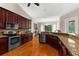 Well-equipped kitchen featuring dark wood cabinets, granite countertops, and stainless steel appliances at 21705 67Th E Ave, Bradenton, FL 34211