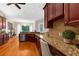 Kitchen featuring granite countertops, wood floors and stainless steel dishwasher at 21705 67Th E Ave, Bradenton, FL 34211