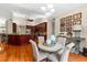Open-concept kitchen and breakfast nook with cherry cabinets, granite countertops, and hardwood flooring at 21705 67Th E Ave, Bradenton, FL 34211
