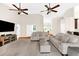 Spacious living room with hardwood floors, ceiling fans, and comfortable seating, perfect for relaxation at 21705 67Th E Ave, Bradenton, FL 34211