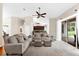 Open living room with neutral tones and natural light, seamlessly flowing into the adjacent kitchen at 21705 67Th E Ave, Bradenton, FL 34211