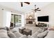 Bright living room with fireplace, ceiling fans and sliding glass doors leading to the pool area at 21705 67Th E Ave, Bradenton, FL 34211