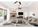 Cozy living room with a brick fireplace, ceiling fans, and sliding doors offering outdoor views at 21705 67Th E Ave, Bradenton, FL 34211