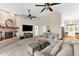 Bright and airy living room with a brick fireplace, hardwood floors, ceiling fans, and comfortable seating at 21705 67Th E Ave, Bradenton, FL 34211