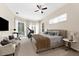 Bright primary bedroom featuring large windows, French doors, and neutral décor at 21705 67Th E Ave, Bradenton, FL 34211