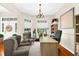 Bright and airy home office with a chandelier, built-in shelving, and a large desk at 21705 67Th E Ave, Bradenton, FL 34211