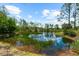 A scenic pond reflects the sky and surrounding trees on a sunny day at 21705 67Th E Ave, Bradenton, FL 34211