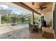 Covered outdoor patio with a pool, spa and dining area at 21705 67Th E Ave, Bradenton, FL 34211