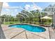 Beautiful screened pool area with lush landscaping and comfortable lounge chairs at 21705 67Th E Ave, Bradenton, FL 34211