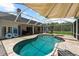 A refreshing pool with an attached spa is enclosed with a lanai and stone patio at 21705 67Th E Ave, Bradenton, FL 34211