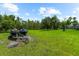Expansive lush lawn features personal watercraft and storage trailer at 21705 67Th E Ave, Bradenton, FL 34211