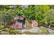 Aerial view of a property, with two structures, surrounded by lush greenery, offering a private setting at 218 32Nd W St, Bradenton, FL 34205