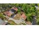 Aerial view of a home with detached garage and lush landscaping, revealing its spacious layout and private setting at 218 32Nd W St, Bradenton, FL 34205