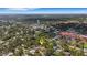 Wide aerial view shows a house located in a green wooded area with nearby city water tower, creating a peaceful ambiance at 218 32Nd W St, Bradenton, FL 34205