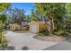 Large driveway featuring a detached garage and shed with mature trees providing shade at 218 32Nd W St, Bradenton, FL 34205