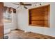 Bedroom with built-in shelving, ceiling fan, and natural light, ready for renovation at 218 32Nd W St, Bradenton, FL 34205