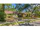 Charming single-story home with a well-maintained lawn and mature trees providing ample shade at 218 32Nd W St, Bradenton, FL 34205