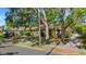 Charming single-story home with mature trees providing shade, located on a street with a brick-paved sidewalk at 218 32Nd W St, Bradenton, FL 34205
