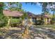 Charming single-story home featuring a well-manicured lawn, mature trees, and a welcoming front entrance at 218 32Nd W St, Bradenton, FL 34205