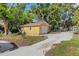 Detached garage with a driveway and mature trees at 218 32Nd W St, Bradenton, FL 34205