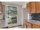 Bright kitchen area featuring wooden cabinets and a large window with outdoor views at 218 32Nd W St, Bradenton, FL 34205