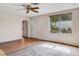 Bright living room featuring hardwood floors, a white front door, and a large window at 218 32Nd W St, Bradenton, FL 34205