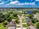 An aerial view of the property shows its location within a beautiful neighborhood near a large pond at 234 Antofagasta St, Punta Gorda, FL 33983