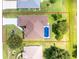 Aerial view of a home with a pool surrounded by green landscaping and a well-maintained yard at 234 Antofagasta St, Punta Gorda, FL 33983