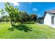 Spacious backyard with mature trees, providing ample shade near the enclosed pool area at 234 Antofagasta St, Punta Gorda, FL 33983