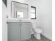 Bathroom features a modern vanity, and a mirror with a window nearby at 234 Antofagasta St, Punta Gorda, FL 33983