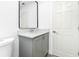 Bathroom features a gray vanity with a modern sink, a sleek mirror, and a nearby toilet at 234 Antofagasta St, Punta Gorda, FL 33983