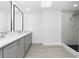 Beautiful bathroom with double sink, vanity, quartz counters and stand-up shower with marble surround at 234 Antofagasta St, Punta Gorda, FL 33983