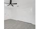 Bedroom features grey tile flooring, a ceiling fan, and a closet with panel doors at 234 Antofagasta St, Punta Gorda, FL 33983