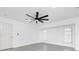 This bedroom features grey wood-look tile flooring and a modern ceiling fan, providing a cozy atmosphere at 234 Antofagasta St, Punta Gorda, FL 33983