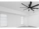 Bright bedroom featuring a ceiling fan, two windows with blinds, and closet with white doors at 234 Antofagasta St, Punta Gorda, FL 33983
