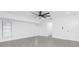 Bedroom features grey wood-look tile flooring and a modern ceiling fan, with two bright windows at 234 Antofagasta St, Punta Gorda, FL 33983