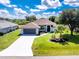 Beautiful single-story home with a well-manicured lawn, lush landscaping, and a freshly sealed driveway at 234 Antofagasta St, Punta Gorda, FL 33983
