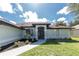 Charming single-story home featuring an arched entryway, manicured landscaping, and a well-maintained lawn at 234 Antofagasta St, Punta Gorda, FL 33983