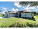 Elegant home with pristine landscaping, enhancing curb appeal and charm at 234 Antofagasta St, Punta Gorda, FL 33983