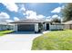 Charming single-story home boasts an attached garage, a well-maintained lawn and manicured landscaping at 234 Antofagasta St, Punta Gorda, FL 33983
