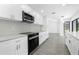 Modern kitchen boasts stainless steel appliances, white cabinets, and sleek countertops at 234 Antofagasta St, Punta Gorda, FL 33983