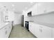 Bright kitchen boasts white cabinetry, quartz countertops, and stainless steel appliances at 234 Antofagasta St, Punta Gorda, FL 33983