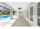 A covered patio with ceiling fan overlooks the screened-in pool at 234 Antofagasta St, Punta Gorda, FL 33983