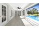 Spacious covered patio overlooks the pool, with tile floor and ceiling fan at 234 Antofagasta St, Punta Gorda, FL 33983