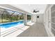 A covered patio with ceiling fan overlooks the screened-in pool at 234 Antofagasta St, Punta Gorda, FL 33983